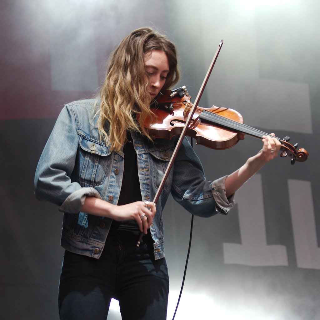 Violinist with calm and joyful facial expression, foggy background